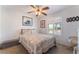 Cozy bedroom featuring a decorative quilt, plantation shutters, and a ceiling fan at 944 Angel Star Ln, Las Vegas, NV 89145