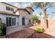 Two-story home with stucco exterior, a blue door, desert landscaping, and a private courtyard at 944 Angel Star Ln, Las Vegas, NV 89145