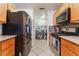 Bright kitchen with stainless steel appliances and granite counters leading into the laundry area at 944 Angel Star Ln, Las Vegas, NV 89145