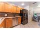 Well-equipped kitchen with stainless steel appliances and wood cabinets, next to laundry area at 944 Angel Star Ln, Las Vegas, NV 89145