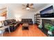 Open living room with hardwood floors, fireplace, and a large flat-screen television at 944 Angel Star Ln, Las Vegas, NV 89145