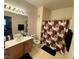 Bathroom featuring a vanity, mirror, and floral shower curtain at 9580 W Reno Ave # 283, Las Vegas, NV 89148