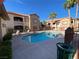 Inviting community pool area surrounded by lush landscaping and lounge chairs at 9580 W Reno Ave # 283, Las Vegas, NV 89148