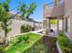A private backyard with a built-in grill, green grass, landscaping, and a covered patio near the pool at 10612 Gum Tree Ct, Las Vegas, NV 89144
