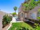 A lovely backyard featuring a pool, desert landscaping, and a covered patio at 10612 Gum Tree Ct, Las Vegas, NV 89144
