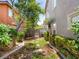 Tranquil backyard showcasing a walkway, mature trees, lush foliage and privacy at 10612 Gum Tree Ct, Las Vegas, NV 89144