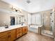 Elegant bathroom featuring dual sinks, a soaking tub, and a separate glass shower at 10612 Gum Tree Ct, Las Vegas, NV 89144