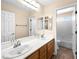 A clean bathroom with a dual sink vanity, large mirror, and a shower-tub combination at 10612 Gum Tree Ct, Las Vegas, NV 89144