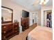 Bedroom featuring a large dresser, TV, ceiling fan and an entry to the other rooms at 10612 Gum Tree Ct, Las Vegas, NV 89144