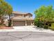 Inviting two-story home featuring a three-car garage and desert landscaping at 10612 Gum Tree Ct, Las Vegas, NV 89144