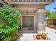 Charming front entrance with a covered porch, double doors, and manicured greenery at 10612 Gum Tree Ct, Las Vegas, NV 89144