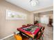 Inviting recreation area featuring a custom game table and natural light from shuttered windows at 10612 Gum Tree Ct, Las Vegas, NV 89144