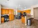 Eat-in kitchen with tile floors, stainless steel appliances, and wooden cabinets at 10612 Gum Tree Ct, Las Vegas, NV 89144