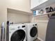 Convenient laundry room is equipped with a modern washer and dryer at 10612 Gum Tree Ct, Las Vegas, NV 89144