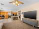 Bright living room featuring modern decor, a large TV, and an adjacent kitchen at 10612 Gum Tree Ct, Las Vegas, NV 89144