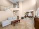 Spacious living room showcasing a staircase, tile floors, and an open floor plan at 10612 Gum Tree Ct, Las Vegas, NV 89144
