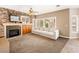 Open living room with a fireplace, a ceiling fan, and lots of natural light at 10612 Gum Tree Ct, Las Vegas, NV 89144