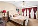 Serene main bedroom with vaulted ceilings, plush carpet, and ample natural light at 10612 Gum Tree Ct, Las Vegas, NV 89144