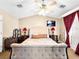 Main bedroom with fan, plush bed, and luxurious curtains at 10612 Gum Tree Ct, Las Vegas, NV 89144
