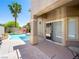 A view of the pool with a palm tree, patio, and sliding glass door access from the house at 10612 Gum Tree Ct, Las Vegas, NV 89144