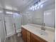 Bathroom with updated vanity, a large mirror, and a glass-enclosed shower at 11185 Saddle Iron St, Las Vegas, NV 89179