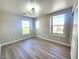 Bright bedroom with hardwood floors and multiple windows for ample natural light at 11185 Saddle Iron St, Las Vegas, NV 89179