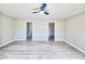 Bedroom with neutral walls, modern flooring, ceiling fan, and access to multiple closets at 11185 Saddle Iron St, Las Vegas, NV 89179