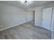 Bedroom featuring mirrored closet doors and new flooring at 11185 Saddle Iron St, Las Vegas, NV 89179