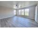 Spacious, bright bedroom with ceiling fan, large windows, and light gray flooring at 11185 Saddle Iron St, Las Vegas, NV 89179