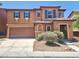 Two-story home featuring a terracotta exterior, a two-car garage and low maintenance landscaping at 11185 Saddle Iron St, Las Vegas, NV 89179