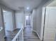 Hallway with neutral walls and flooring leads to various rooms with white doors at 11185 Saddle Iron St, Las Vegas, NV 89179