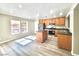 Charming eat-in kitchen features stainless appliances, wood cabinets and center island, bathed in natural light at 11185 Saddle Iron St, Las Vegas, NV 89179