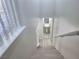 Staircase leads to a powder room with a pedestal sink and modern fixtures at 11185 Saddle Iron St, Las Vegas, NV 89179
