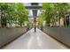 Lush walkway lined with greenery and modern planters leads through the property, creating a serene, welcoming atmosphere at 11441 Allerton Park Dr # 212, Las Vegas, NV 89135