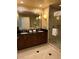Bathroom boasts a double sink vanity with granite countertops and a glass-enclosed shower at 125 E Harmon Ave # 2918, Las Vegas, NV 89109