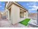 A backyard with pavers, artificial turf, and a modern water fountain at 12816 Alcores St, Las Vegas, NV 89141