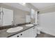 Bathroom featuring double sinks with granite countertops and tub with shower at 12816 Alcores St, Las Vegas, NV 89141