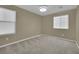 Cozy bedroom featuring two windows allowing natural light and plush carpeting at 12816 Alcores St, Las Vegas, NV 89141