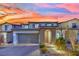 Charming two-story home with a brick driveway, attached two-car garage, and manicured landscaping at 12816 Alcores St, Las Vegas, NV 89141