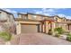 Charming two-story home featuring a brick driveway, arched entry and tidy front landscaping at 12816 Alcores St, Las Vegas, NV 89141