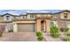 Charming two-story home featuring a brick driveway, arched entry and tidy front landscaping at 12816 Alcores St, Las Vegas, NV 89141