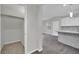 Hallway view into the kitchen with gray backsplash and floors and a carpeted closet at 12816 Alcores St, Las Vegas, NV 89141