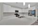 Stylish kitchen with a large island, stainless steel appliances, and modern light fixtures at 12816 Alcores St, Las Vegas, NV 89141