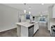 Open concept kitchen with large island, stainless appliances, and sleek white cabinetry at 12816 Alcores St, Las Vegas, NV 89141