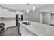 Modern kitchen showcasing an island with a double sink and stainless steel appliances at 12816 Alcores St, Las Vegas, NV 89141