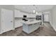 Bright, open kitchen featuring modern white cabinets, large island and stainless steel appliances at 12816 Alcores St, Las Vegas, NV 89141