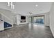 Bright living room featuring a modern fireplace, staircase, and large sliding glass doors to the patio at 12816 Alcores St, Las Vegas, NV 89141