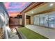 Gorgeous covered patio overlooking manicured lawn, water feature, and an open-concept indoor living space at 12816 Alcores St, Las Vegas, NV 89141
