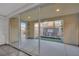 Covered patio with large sliding glass doors and a water feature in the backyard at 12816 Alcores St, Las Vegas, NV 89141
