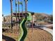 Community playground with slide and climbing structure, set in a landscaped common area at 12816 Alcores St, Las Vegas, NV 89141
